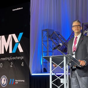 Photo of John Wilczynski speaking at a podium at America Makes' annual members meeting