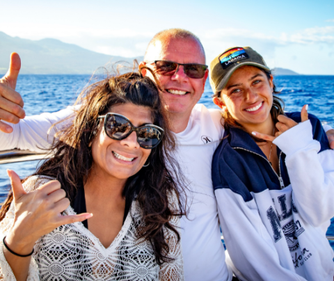 Photo of Madhu Stemmerman with her husband and daughter sitting on a boat.