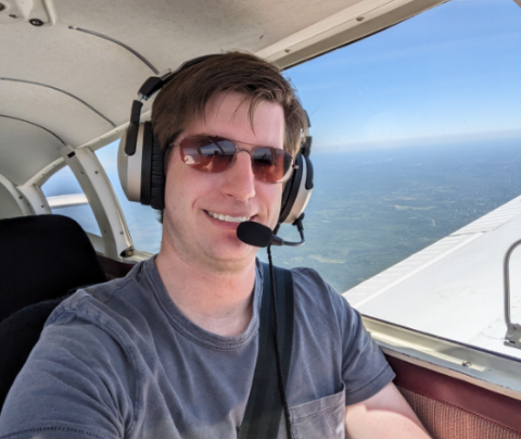 Photo of Alex Repucci piloting a plane.