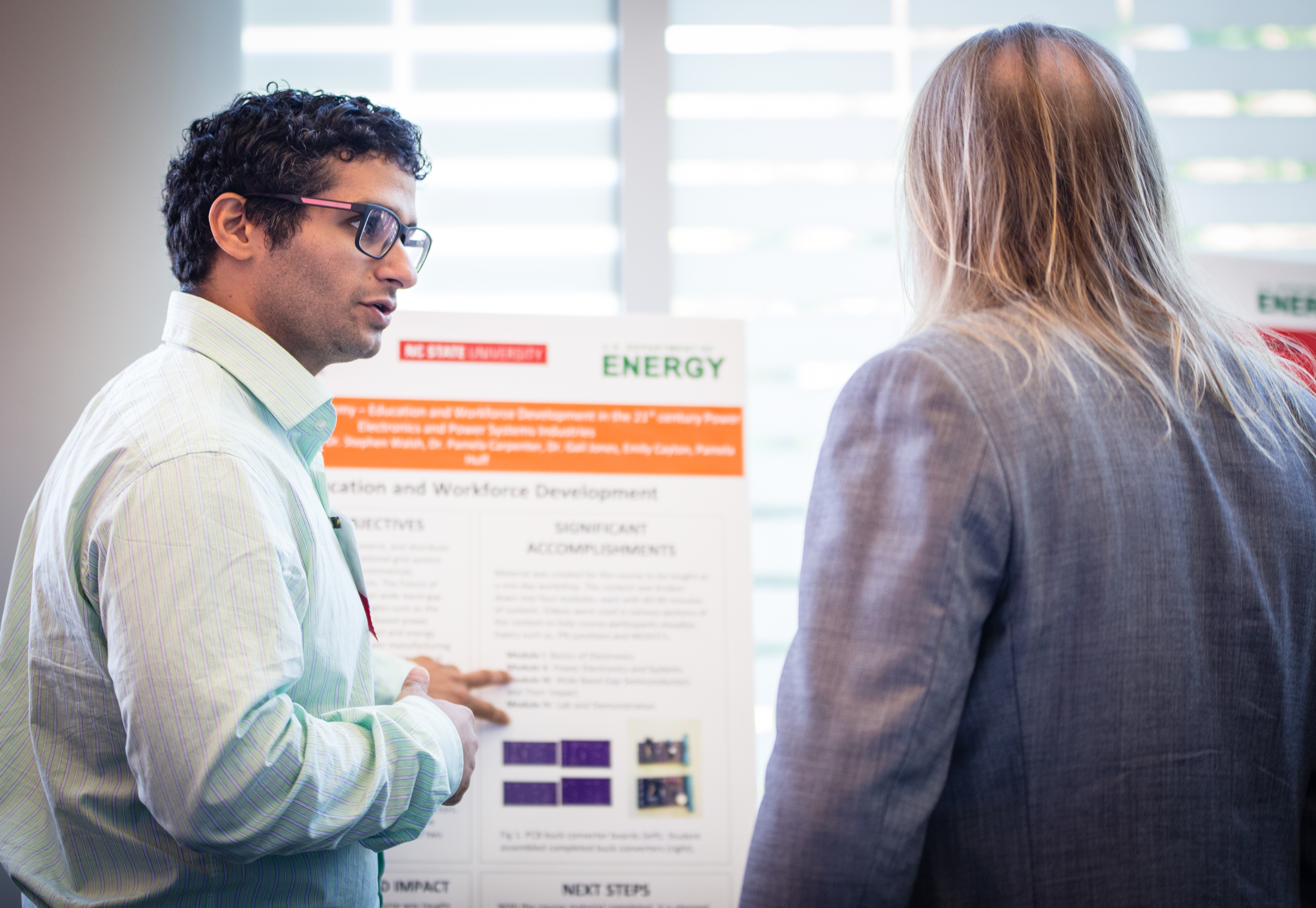 Picture of Ph.D candidate Alireza Dayerizadeh discussing esearch with Dr. Allen Hefner